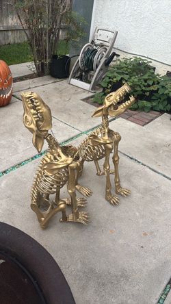 2 golden howling wolf skeletons