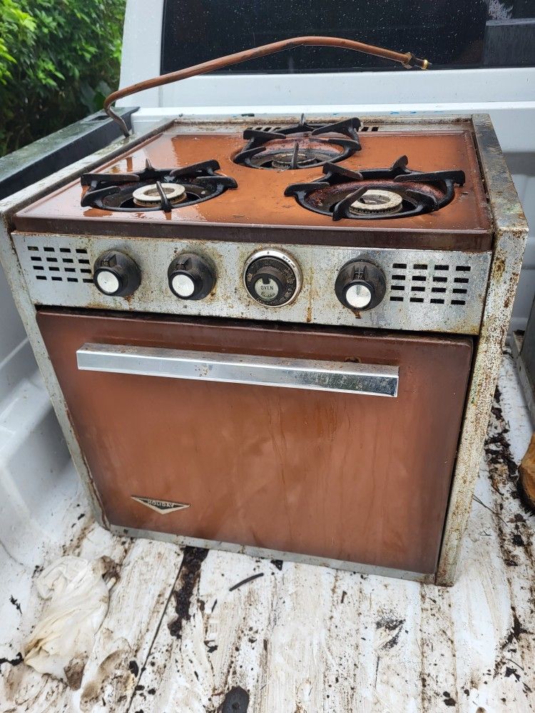 Nineteen sixty retro camper travel trailer refrigerator and oven combo