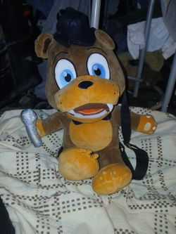 a Bioworld Five Nights At Freddy's Freddy Fazbear plush backpack featuring large blue embroidered eyes