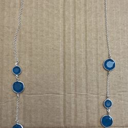  Silver toned necklace with blue stones.
