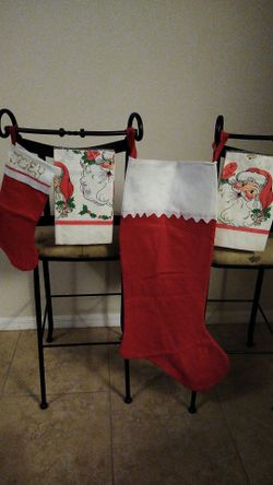 Two Christmas stockings standard size and 3' ft with two santa paper tablecloths