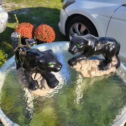 vintage Mid-Century Modern black panther sculptures, likely made of ceramic or resin