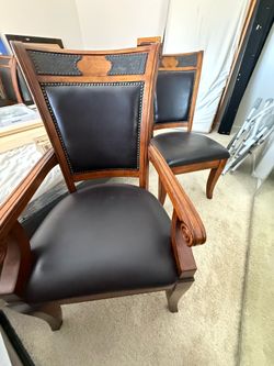 Dinning table with 6 and 2 arms chairs chairs solid wood, leather seats. 48” inches wide and 79” inches long chairs with 39” inches tall and 20” inche
