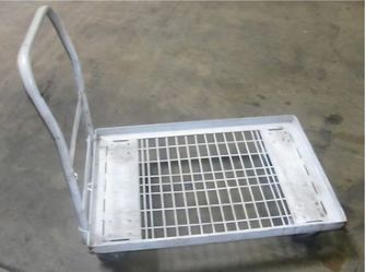 Durable metal platform cart has a gray finish and a wire mesh center deck. This industrial trolley is equipped with a sturdy push handle and four heav