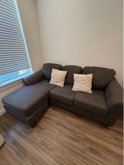 Brown couch with 2 pillows