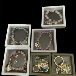 4 Multi-coloured beaded bracelets, two silver bracelets and two gold keychains.