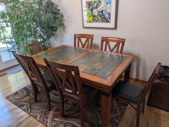 Slate-topped dining room table with extra leaf and 4 chairs