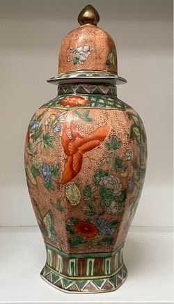 A vintage Chinese porcelain lidded ginger jar or baluster urn decorated in a striking famille verte / famille rose enamel style.