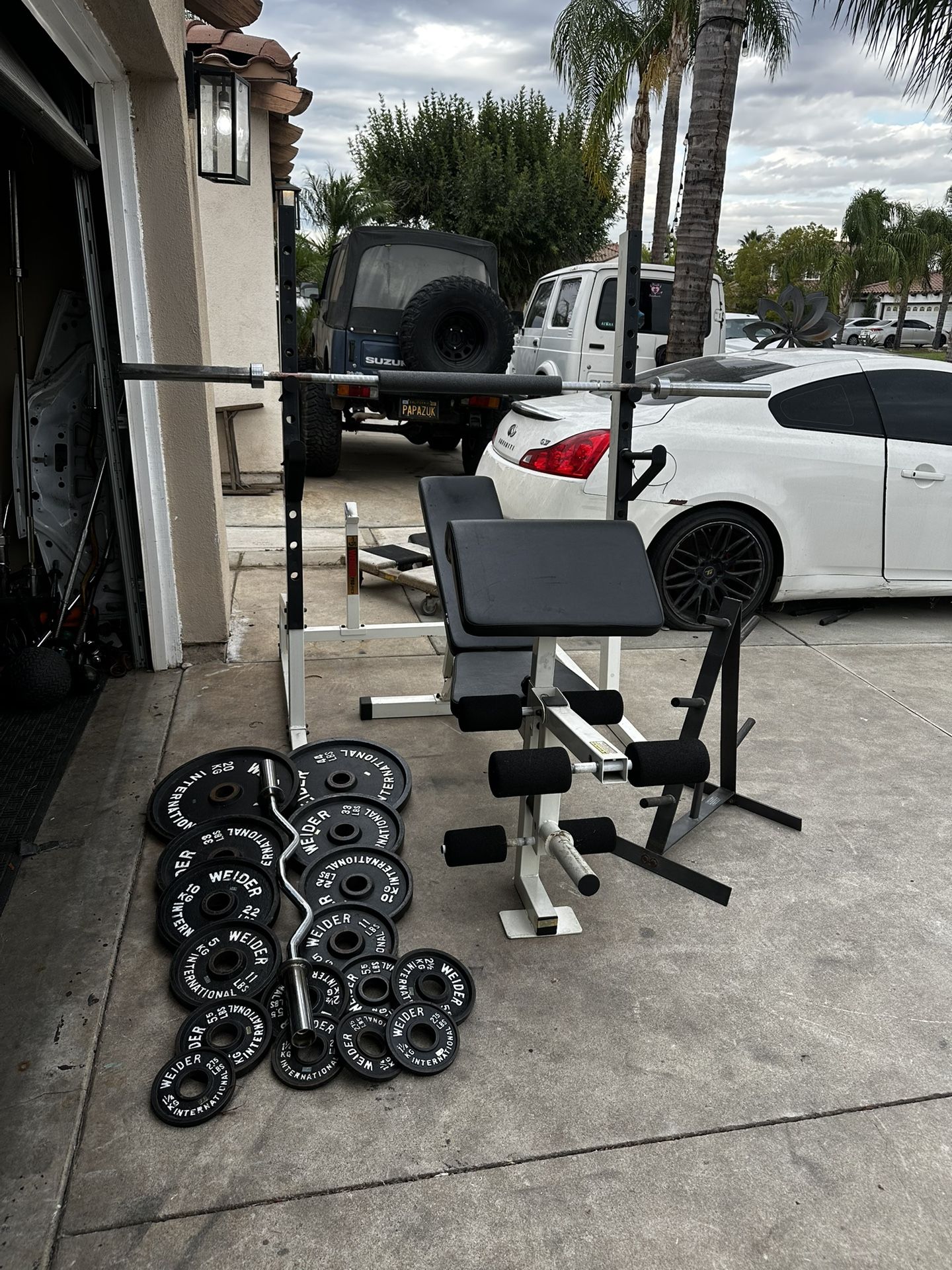Bench press/squat rack with 7ft 45lbs bar plus 252lbs of Olympic weights and curl bar and weights tree