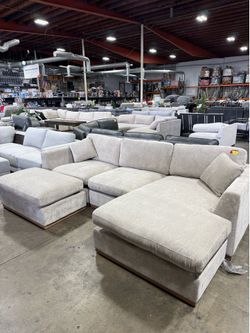 Light beige fabric sectional sofa with chaise in new condition