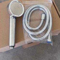 handheld shower head and a coiled shower hose.