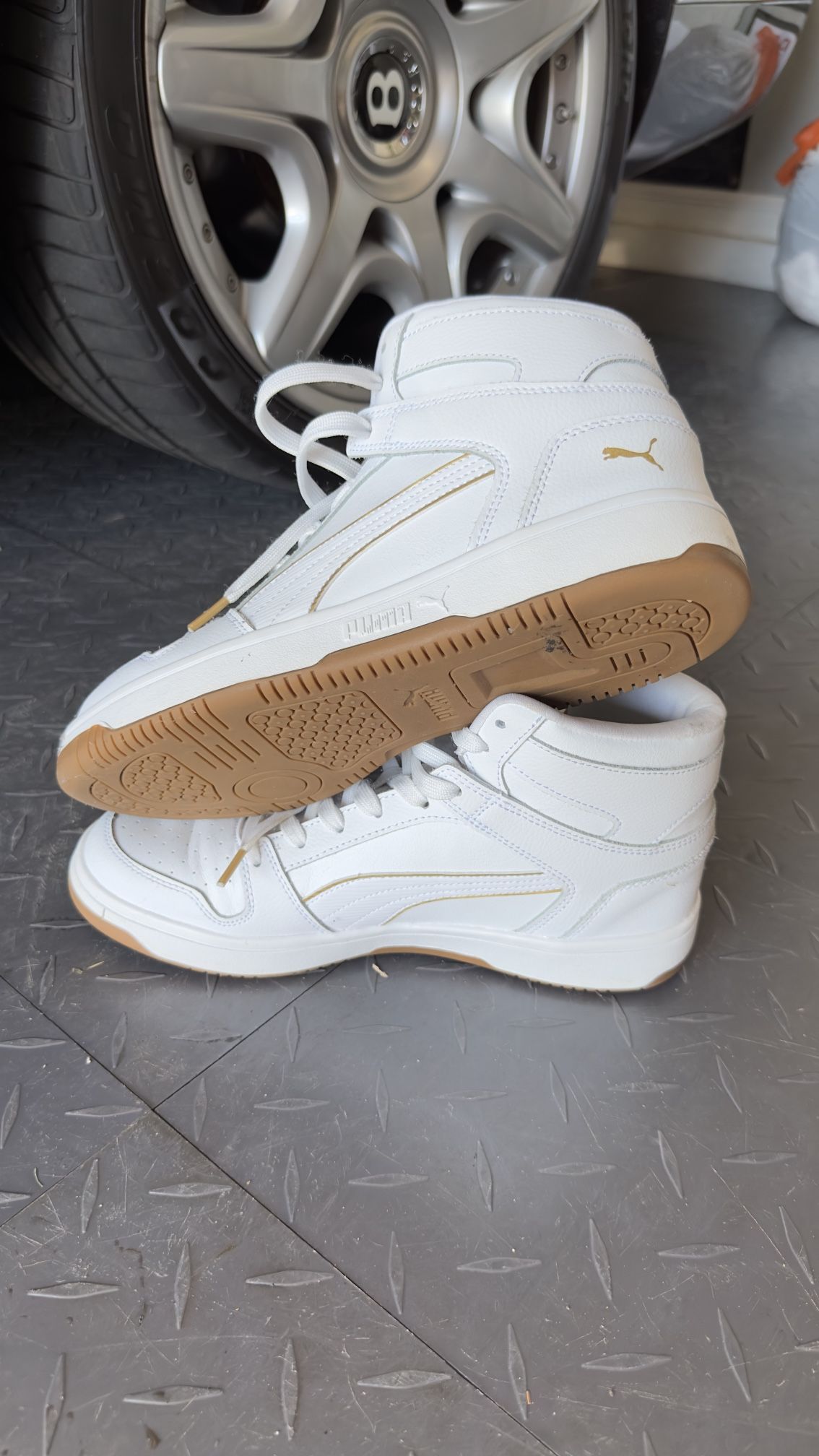 This is a pair of Puma SoftFoam+ high-top sneakers