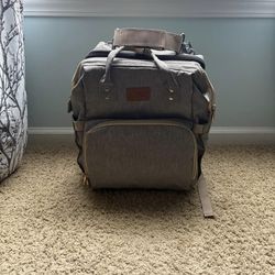 Diaper book bag with change table and pad
