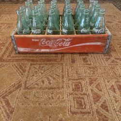 Antique Coke bottles in wooden case