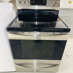 Kenmore stainless steel stove with a receipt for a 90-day warranty