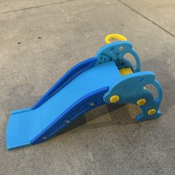 Brand new kids slide with basketball hoop and basketball