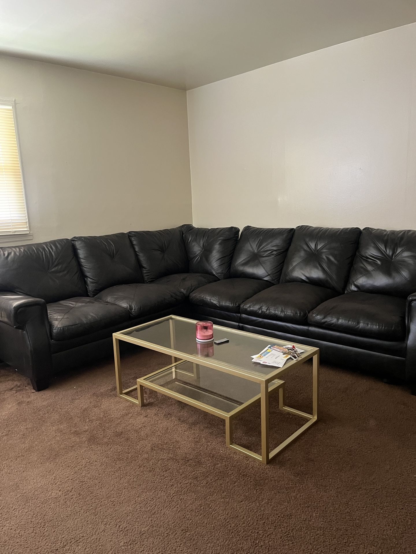 Black leather sectional & Gold Glass Table.