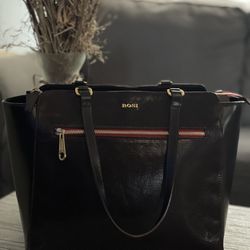 This Vintage BOSI Tote is a Stunning Addition to any Wardrobe. The Deep Burgundy\Merlot Red Leather Exterior is Accented with Studs and Gold Hardware,