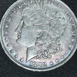 1882 silver Morgan -o with a halo around the whole perimeter of a bluish  green