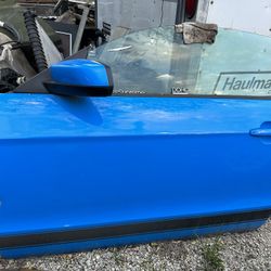 2013 mustang Drivers Door with power mirror. No door panel has minor damage from storage on fron