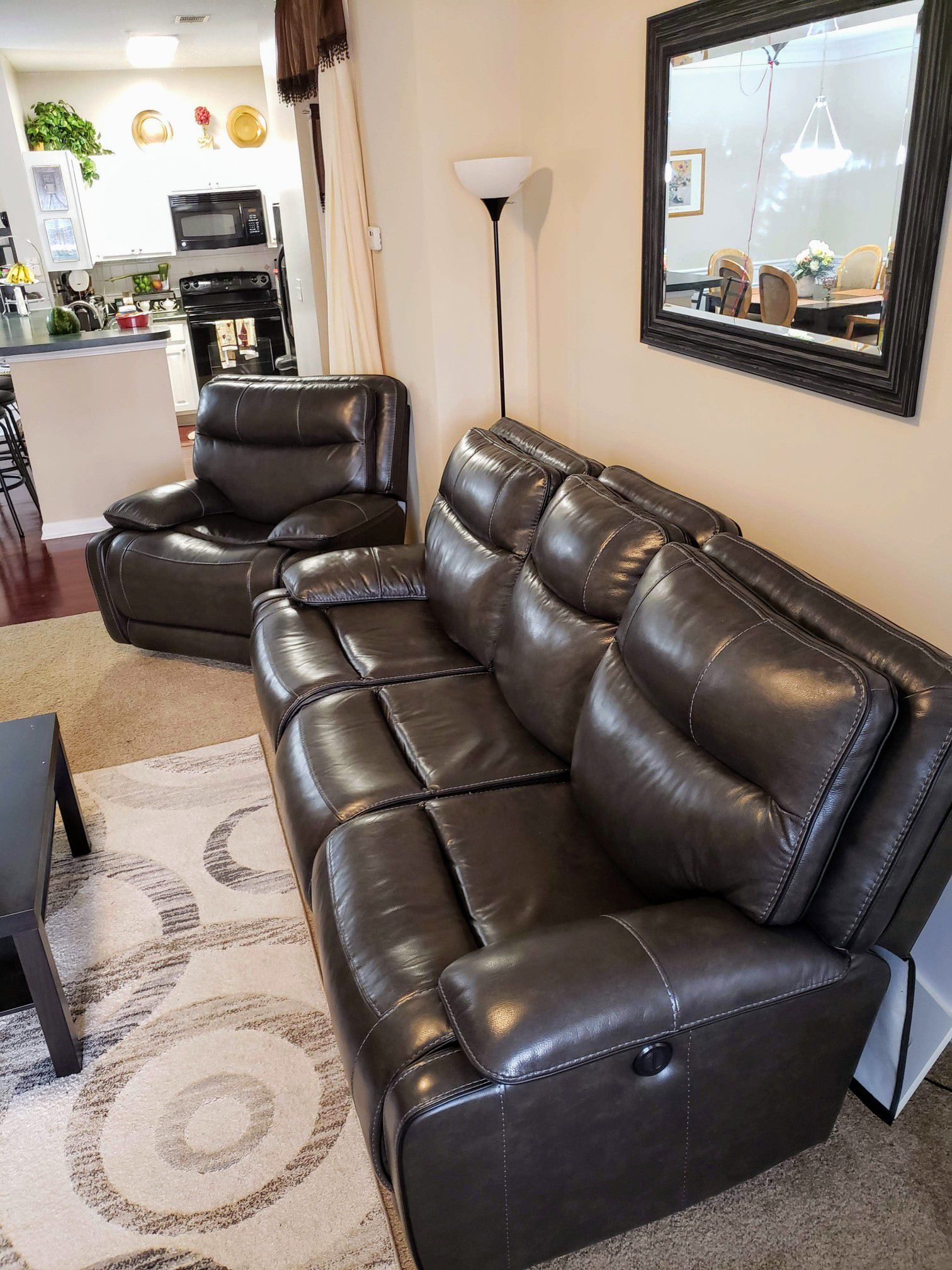 Black leather reclining sofa with power headrest and lumbar support