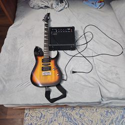 Garry Guitar With Cords And Amplifier And Stand