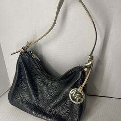 Michael Kors black & tan pebbled leather hobo bag.