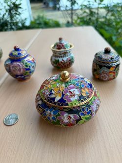 A beautiful collection of 4 vintage cloisonné miniature boxes in various vibrant colors and floral patterns.