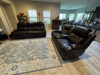 Mocha dark brown zero clearance power reclining couch and loveseat. There is slight wear on one of the couch cushions. Four power recliners with adjus