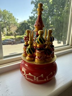 This is a hand-painted wooden model of Saint Basil's Cathedral, located in Moscow's Red Square.
