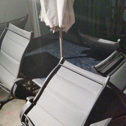 Table Set And Six Chairs With An Umbrella 