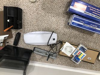 Assorted office equipment and supplies fax machines laminating machines paper cutters sort of pens and other sort minutes