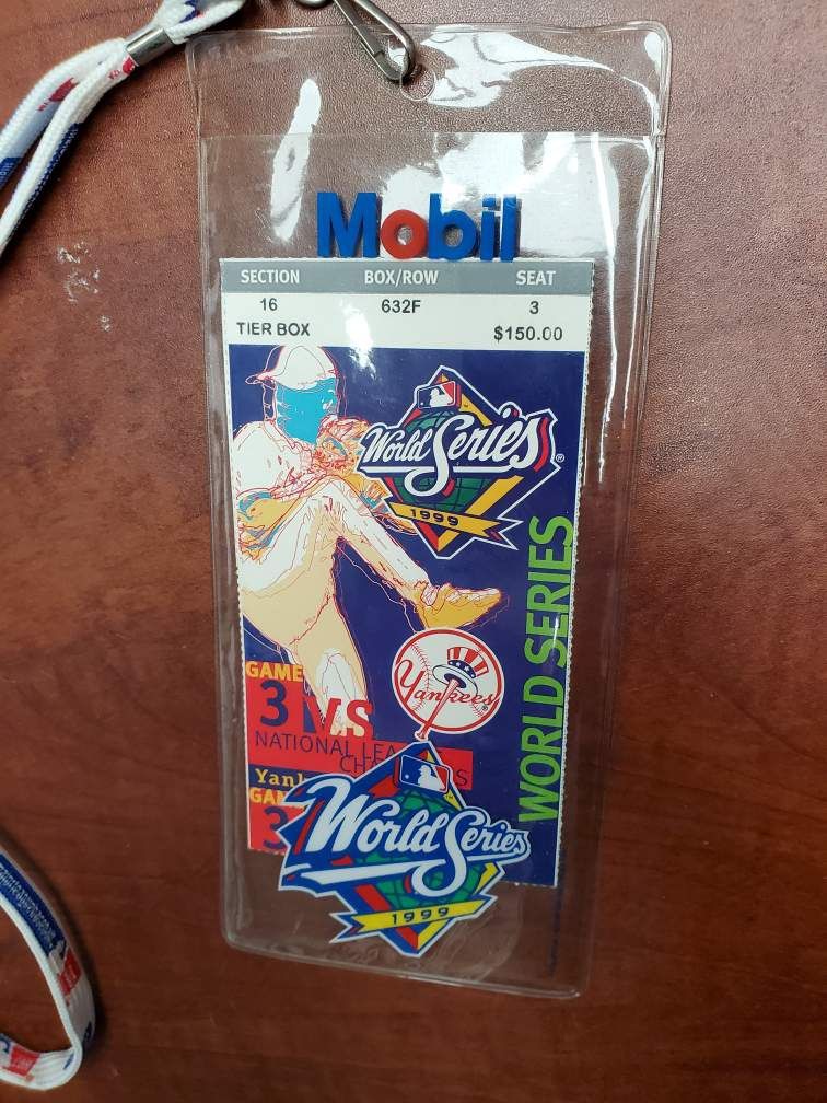 1999 World Series Game 3 ticket, plastic sleeve & lanyard.
