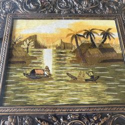 Hand-embroidered silk threads on fabric depicting Traditional Vietnamese rural landscape rice paddies and river scenes.