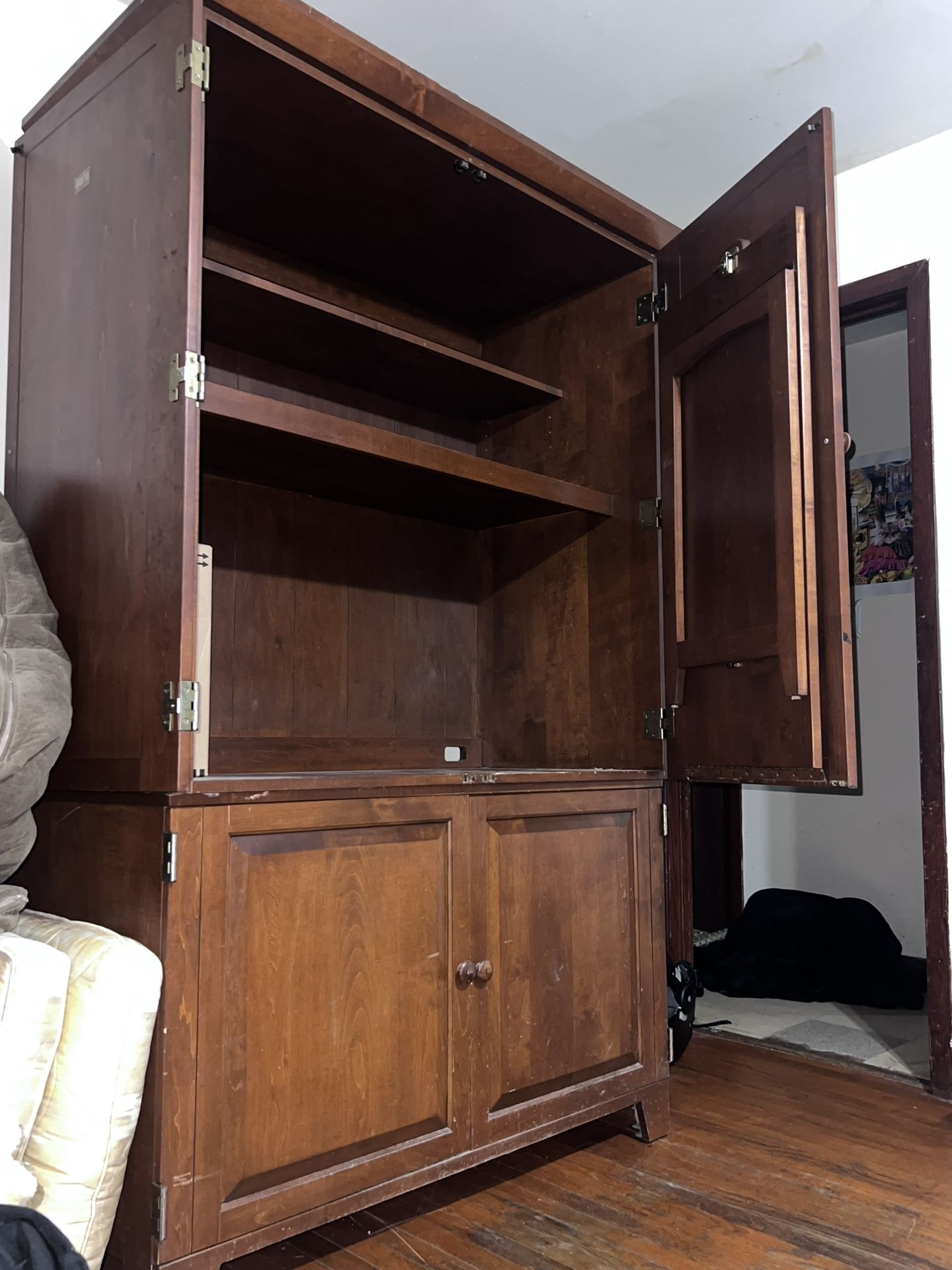 Spacious wooden cabinet with shelves, Doors and a pullout Table