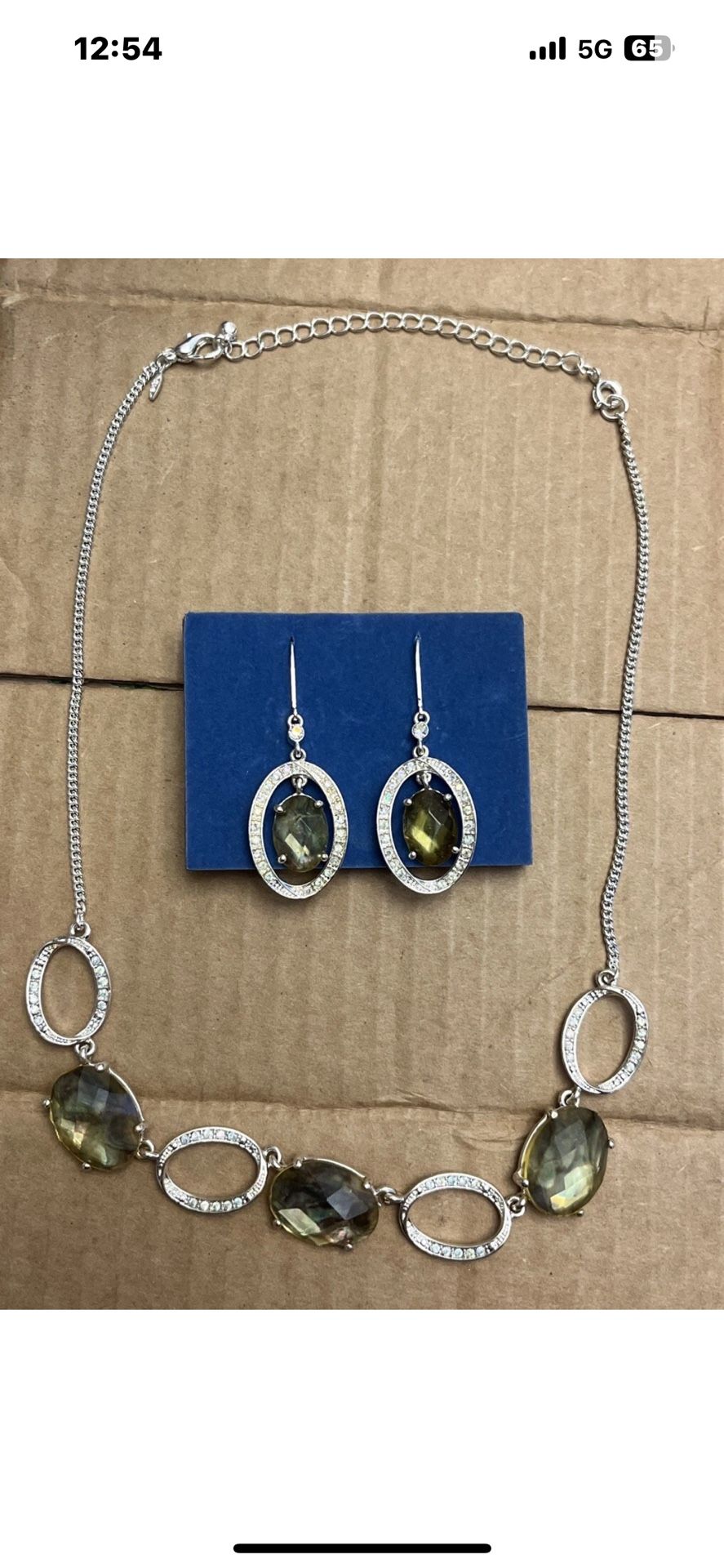 Silver toned bubble necklace with green and iridescent rhinestones and matching earrings.