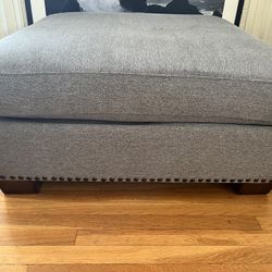Large Upholstered Ottoman – Gray Fabric with Nailhead Trim