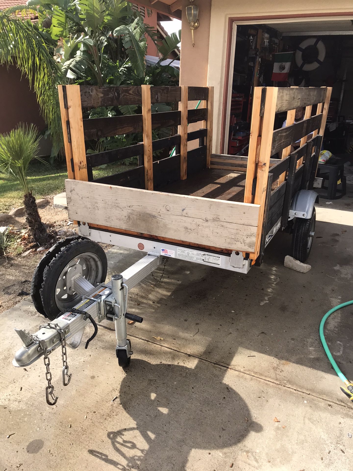 Trailer 4x8 Utility for motorcycles landscaping tools tilt up with plates and pink on hand
