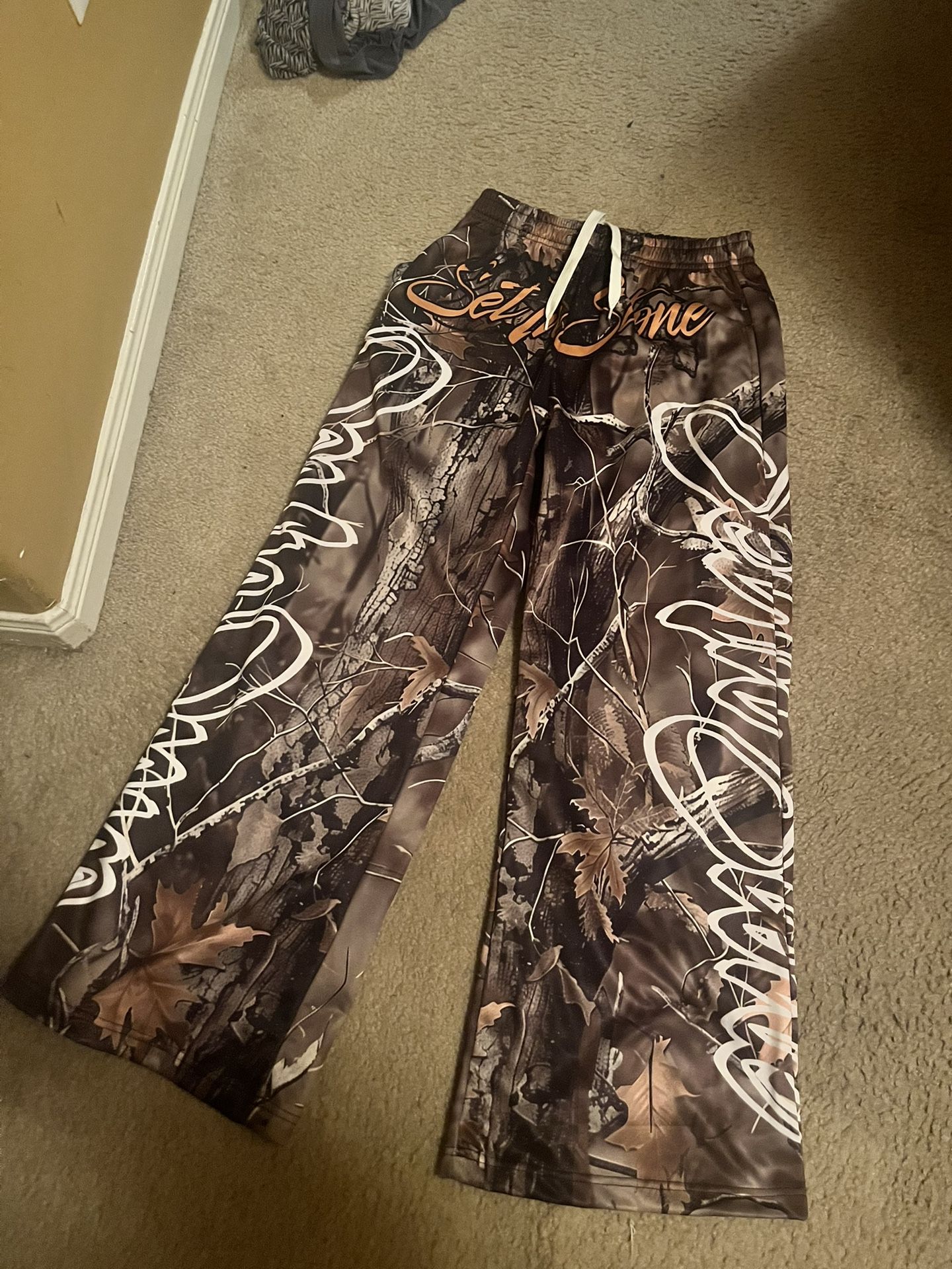 Brown and tan camo sweatpants with a relaxed fit