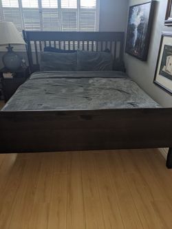 Brown wodden queen size IKEA bed frame