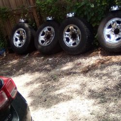 Four  Rims On Tires With Caps