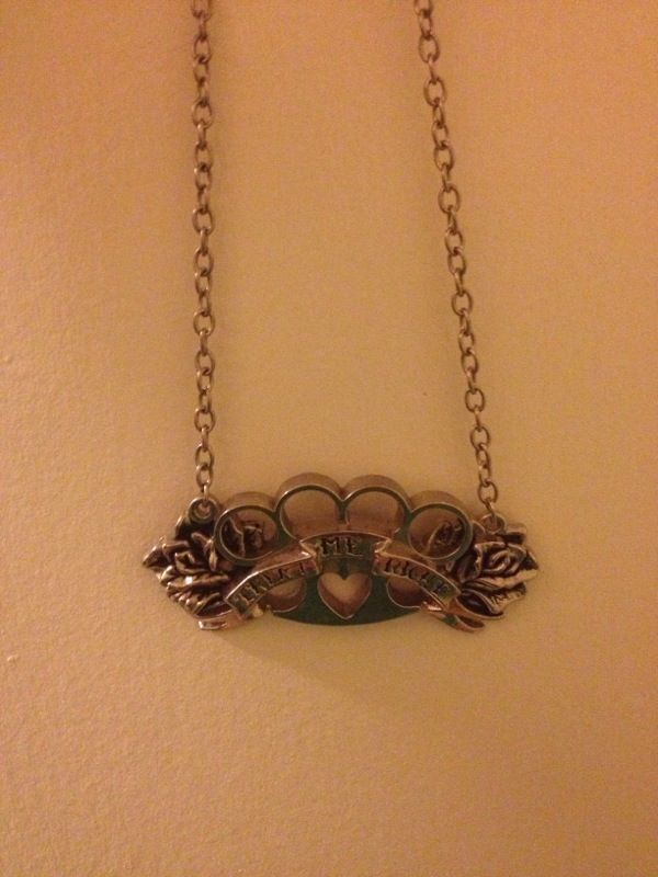 Rock rebel necklace says "treat me right" brass knuckles