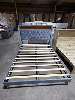 Grey coral fleece upholstered bed frame with a tall headboard. Queen size, featuring built-in charging outlets and a studded design on both sides.(gre