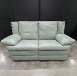 Charming Mint Green Leather Two-Seater Sofa with Plush Padded Arms