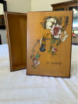 A vintage Chinese lacquered wooden trinket box with hand-painted bird and floral motifs.
