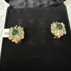 Diamond and emerald earrings made with natural, not lab-grown stones. The total weight of the diamonds is 2 carats, the total weight of the two emeral