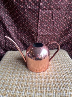 Rose gold colored watering can