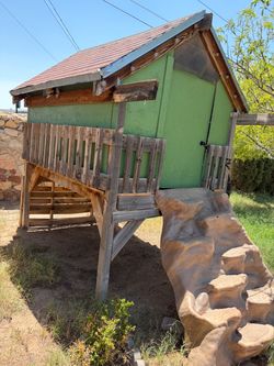 Elevated Wooden Playhouse with Shingle Roof