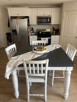 Counter height rustic farm style table with 4 chairs.