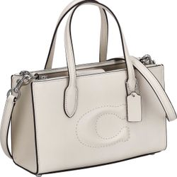 This is a Coach Nina Small Tote bag in refined calf leather and the color is likely "chalk" or a similar light hue